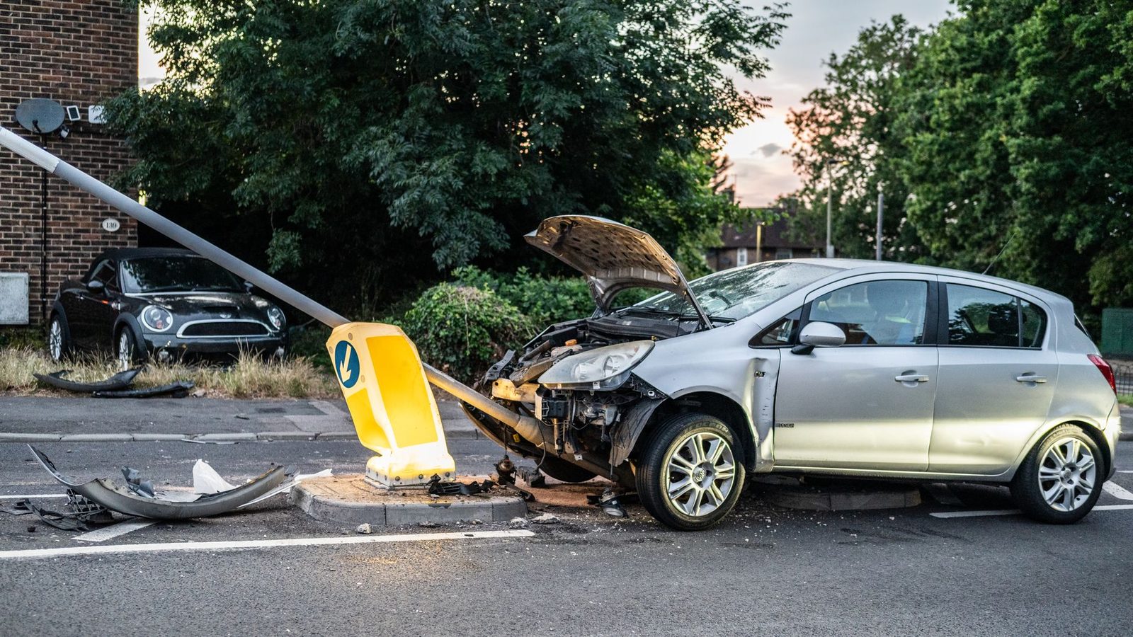 A damaged car rests against a lamp post on a London street at twilight.
*Note: The photo shows a London street, but the page is about Georgia, so the alt text describes the image as it is. If you have a Georgia-specific photo, it would be a better fit for this page.*