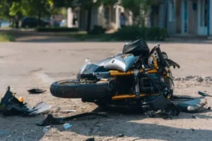 A motorcyle on the ground after an accident.