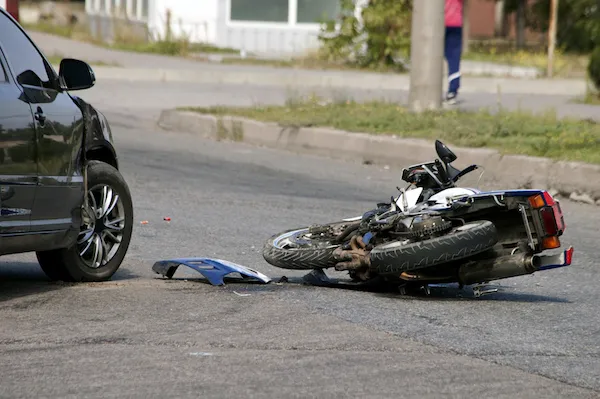 Motorcycle Damaged and Lying on the Street After Crash