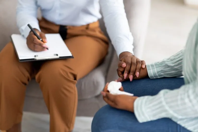 An attorney consoling a client.