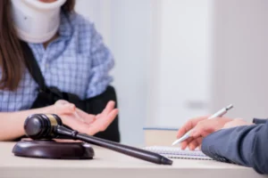 A person with a neck brace, talking with a lawyer.