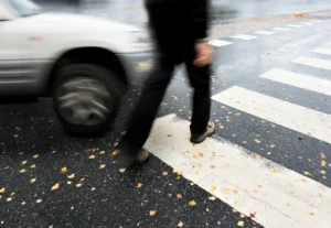 A pedestrian crossing the road.