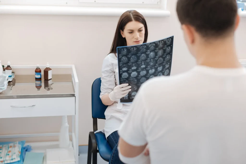 A doctor reviewing an MRI scan with a patient.