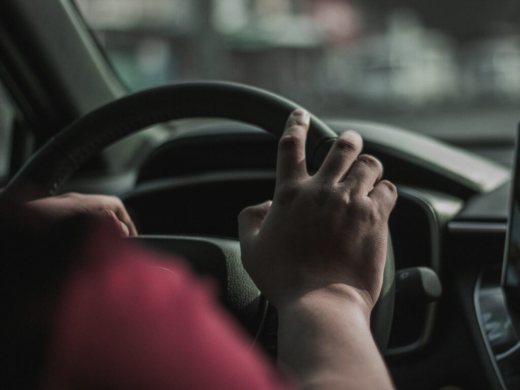 close up of drivers hand in car