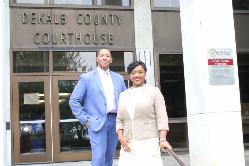 Attorney Madden and Robinson standing in front of the DeKalb County Courthouse entrance.